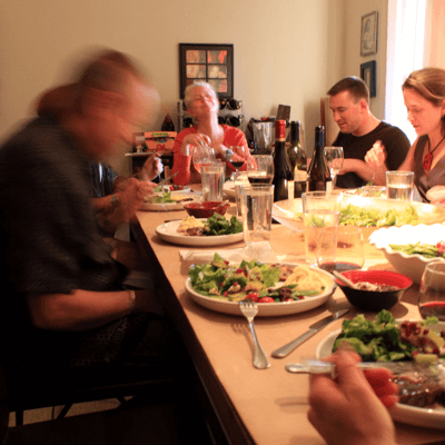 Image of a caucasian family sitting around a dinner table have a meal for innerVelocity.bike.